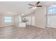 Open concept living area with kitchen, vinyl flooring, and ceiling fan at 3846 Long Grove Ln, Port Orange, FL 32129