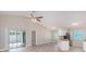 Open living room and kitchen with vaulted ceiling and vinyl plank flooring at 3846 Long Grove Ln, Port Orange, FL 32129