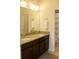 Bathroom vanity with dual sinks, granite countertops, and ample storage at 430 Captiva Dr, Davenport, FL 33896