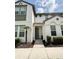 Charming two-story townhome featuring a light gray front door and well-maintained landscaping at 430 Captiva Dr, Davenport, FL 33896