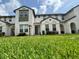 Inviting two-story townhome with fresh green lawn, well-maintained landscaping, and bright natural light at 430 Captiva Dr, Davenport, FL 33896