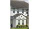 Charming townhome with white exterior, arched windows, and well-maintained landscaping at 430 Captiva Dr, Davenport, FL 33896