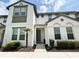 Well-maintained townhome with front yard with tidy landscaping and a gray front door at 430 Captiva Dr, Davenport, FL 33896