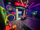 Colorful game room with neon lights, pool table, ping pong table, and fun wall decor at 430 Captiva Dr, Davenport, FL 33896