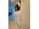 Tiled hallway with the view of a living area and decorative painting on the wall at 430 Captiva Dr, Davenport, FL 33896