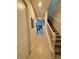 Well-lit hallway with tile flooring leading to stairs and living area at 430 Captiva Dr, Davenport, FL 33896