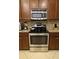 This modern kitchen is equipped with stainless steel appliances and sleek brown cabinetry at 430 Captiva Dr, Davenport, FL 33896