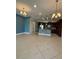 Bright open kitchen with tile floors, granite counters, stainless appliances and modern lighting at 430 Captiva Dr, Davenport, FL 33896