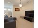 Comfortable living space with neutral colors, a sectional sofa, and a large television at 430 Captiva Dr, Davenport, FL 33896