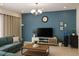 Bright living room featuring modern decor, a comfortable sofa, and a large television at 430 Captiva Dr, Davenport, FL 33896