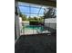 Private screened-in pool with an anchor decoration and brick paved patio at 430 Captiva Dr, Davenport, FL 33896