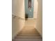 Carpeted stairs leading upstairs, with a decorative painting on the wall at 430 Captiva Dr, Davenport, FL 33896