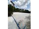 Community sand volleyball court with net surrounded by landscaping on a sunny day at 430 Captiva Dr, Davenport, FL 33896