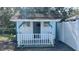 Charming small shed with white exterior and porch at 5958 Lawnview Dr, Orlando, FL 32812