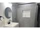 Updated bathroom with gray tile, a new vanity, and a walk-in shower at 5958 Lawnview Dr, Orlando, FL 32812