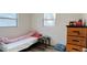 Cozy bedroom with twin bed, dresser, and window at 5958 Lawnview Dr, Orlando, FL 32812