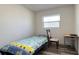 Bright bedroom with twin bed, chair, and workspace at 5958 Lawnview Dr, Orlando, FL 32812