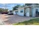 House exterior with driveway, landscaping, and parked car at 5958 Lawnview Dr, Orlando, FL 32812