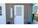 Modern front door with wood and metal accents at 5958 Lawnview Dr, Orlando, FL 32812
