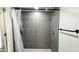 Clean shower with gray tile and a white shower curtain at 5958 Lawnview Dr, Orlando, FL 32812