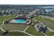 Community pool, playground, and homes surrounding a lake at 613 Greymount St, Davenport, FL 33837