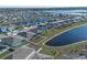 Aerial view showcasing a house's backyard and lake at 613 Greymount St, Davenport, FL 33837