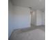 Spacious bedroom with carpeted floor and hallway access at 613 Greymount St, Davenport, FL 33837