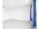 Simple bedroom with tile floor and window with blue curtains at 613 Greymount St, Davenport, FL 33837