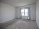 Spacious bedroom with carpeted floor and large window at 613 Greymount St, Davenport, FL 33837