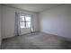 Bright bedroom with carpeted floor and large window at 613 Greymount St, Davenport, FL 33837