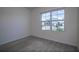 Well-lit bedroom featuring carpet and a window overlooking the street at 613 Greymount St, Davenport, FL 33837
