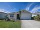 One-story home with a two-car garage and landscaped lawn at 613 Greymount St, Davenport, FL 33837