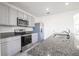 Modern kitchen with stainless steel appliances and granite countertops at 613 Greymount St, Davenport, FL 33837