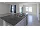Kitchen island with a double sink and granite countertop at 613 Greymount St, Davenport, FL 33837