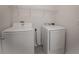 Laundry room with washer, dryer, and overhead shelving at 613 Greymount St, Davenport, FL 33837