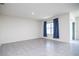 Bright living room with tile floors and sliding glass doors at 613 Greymount St, Davenport, FL 33837