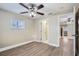 Spacious bedroom with hardwood floors and ceiling fan at 613 Ross St, Leesburg, FL 34748