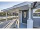 Dark gray front door with a glass oval accent at 613 Ross St, Leesburg, FL 34748