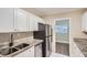 Modern kitchen with white cabinets and granite countertops at 613 Ross St, Leesburg, FL 34748