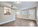 Bright living room with hardwood floors and kitchen view at 613 Ross St, Leesburg, FL 34748