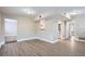 Open concept living area with hardwood floors and kitchen at 613 Ross St, Leesburg, FL 34748