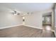 Living room with hardwood floors and access to kitchen at 613 Ross St, Leesburg, FL 34748