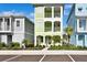 Three-story light green house with white accents and landscaping at 8049 Lost Shaker Ln, Kissimmee, FL 34747
