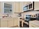 Modern kitchen with white cabinets, stainless steel appliances at 8049 Lost Shaker Ln, Kissimmee, FL 34747