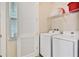 Convenient laundry room with washer, dryer, and shelving at 8049 Lost Shaker Ln, Kissimmee, FL 34747