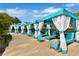 Luxury pool cabanas with white curtains and seating at 8049 Lost Shaker Ln, Kissimmee, FL 34747