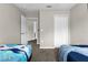 Shared bedroom with two twin beds and access to bathroom at 8558 Crystal Cove Loop, Kissimmee, FL 34747