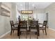 Open dining area with a farmhouse-style table and kitchen views at 8558 Crystal Cove Loop, Kissimmee, FL 34747