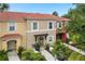 Two-story townhome with terracotta roof and landscaped yard at 8558 Crystal Cove Loop, Kissimmee, FL 34747