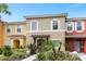 Two-story townhome with landscaping and walkway at 8558 Crystal Cove Loop, Kissimmee, FL 34747